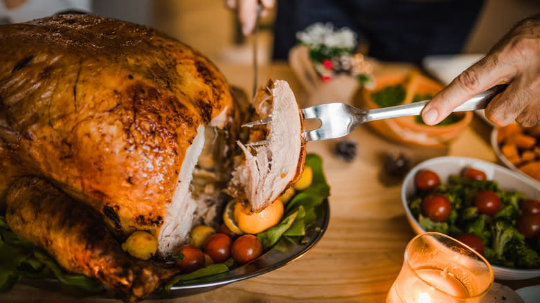 Fork skewering slice of whole turkey