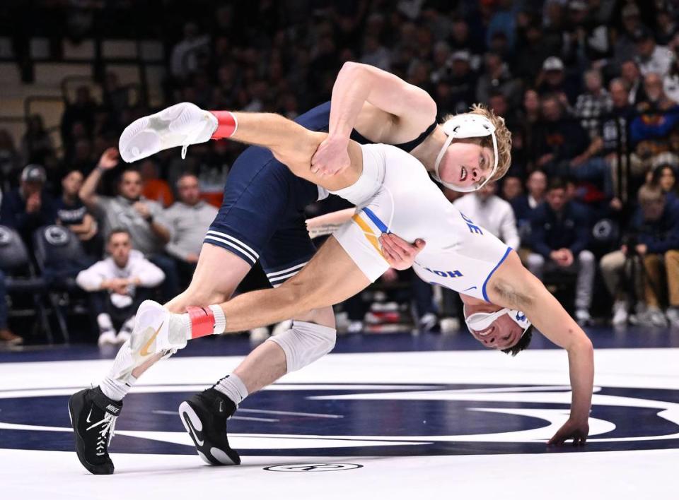 Penn State’s Braeden Davis takes down Hofstra’s Dylan Acevedo (125 lbs) during Sunday’s match at Rec Hall at University Park. Davis defeated Acevedo, 11-2. Penn State defeated Hofstra, 43-10.