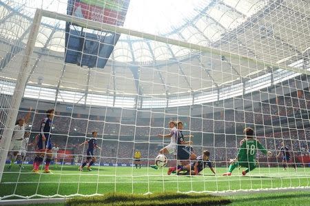 Jul 5, 2015; Vancouver, British Columbia, CAN; United States midfielder Carli Lloyd (10) watches her shot go in for a goal against Japan goalkeeper Ayumi Kaihori (18) in the first half of the final of the FIFA 2015 Women's World Cup at BC Place Stadium. Anne-Marie Sorvin-USA TODAY Sports