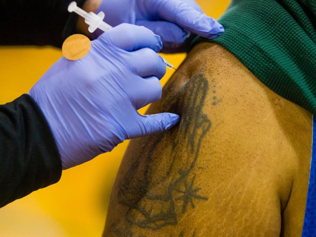 Meijer pharmacist Amy Jennings administers a COVID-19 vaccination to head of security Greg Brown Thursday, March 4, 2021 at Brown Middle School. 