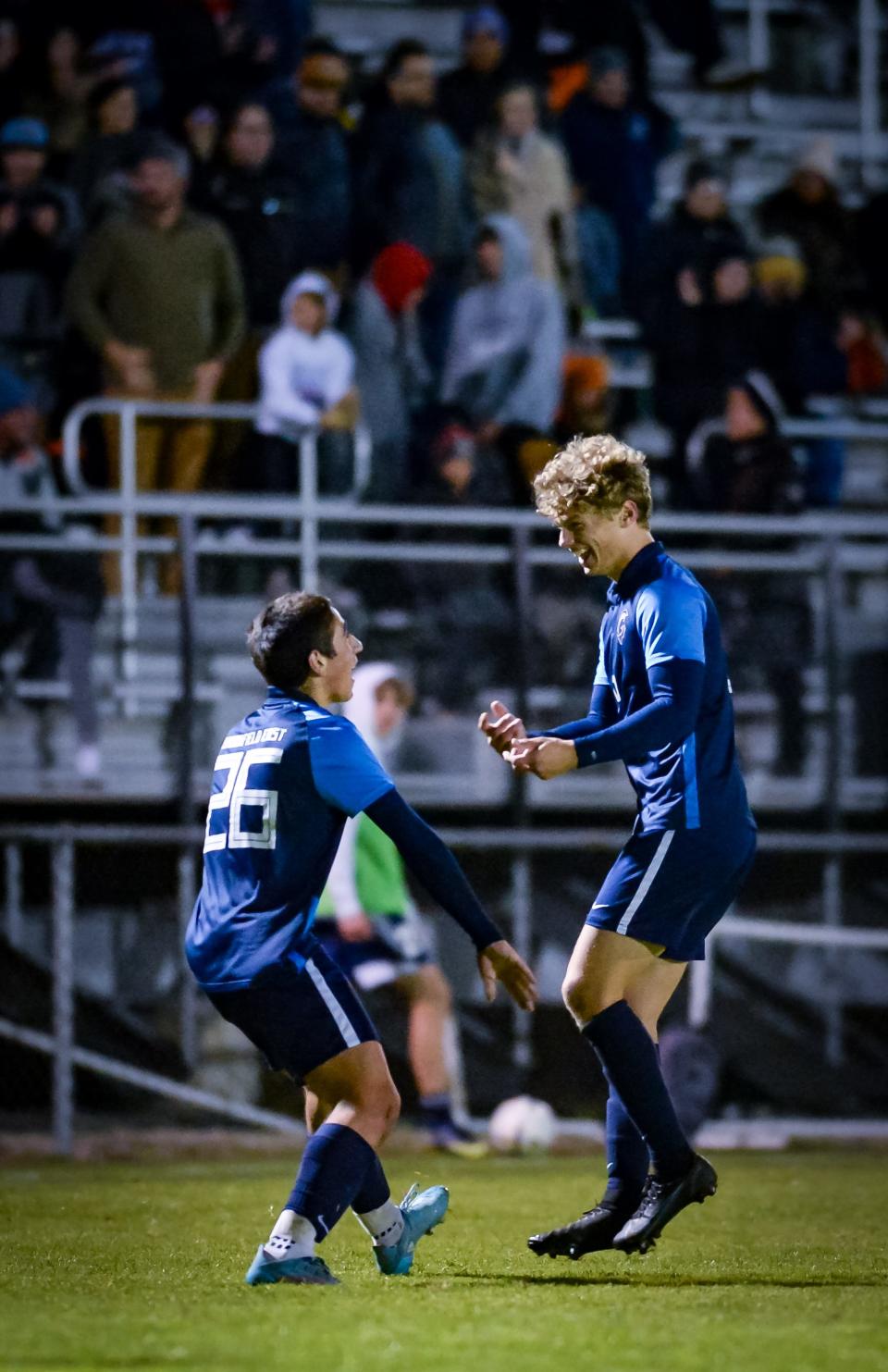 Brookfield East forward Emre Evran (26) and defender Ryan Berghauer celebrate Evran's goal during a 2022 match against Whitefish Bay.