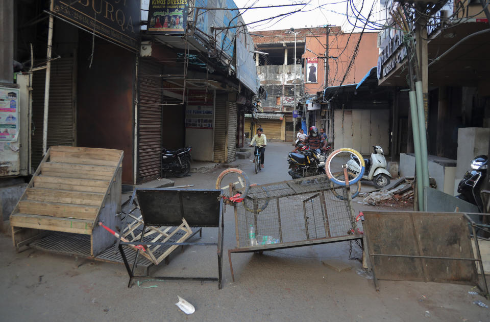 A street is locked down as a precautionary measure against COVID-19 in Hyderabad, India, Monday, March 23, 2020. Authorities have gradually started to shutdown much of the country of 1.3 billion people to contain the outbreak. For most people, the new coronavirus causes only mild or moderate symptoms. For some it can cause more severe illness. (AP Photo/Mahesh Kumar A.)