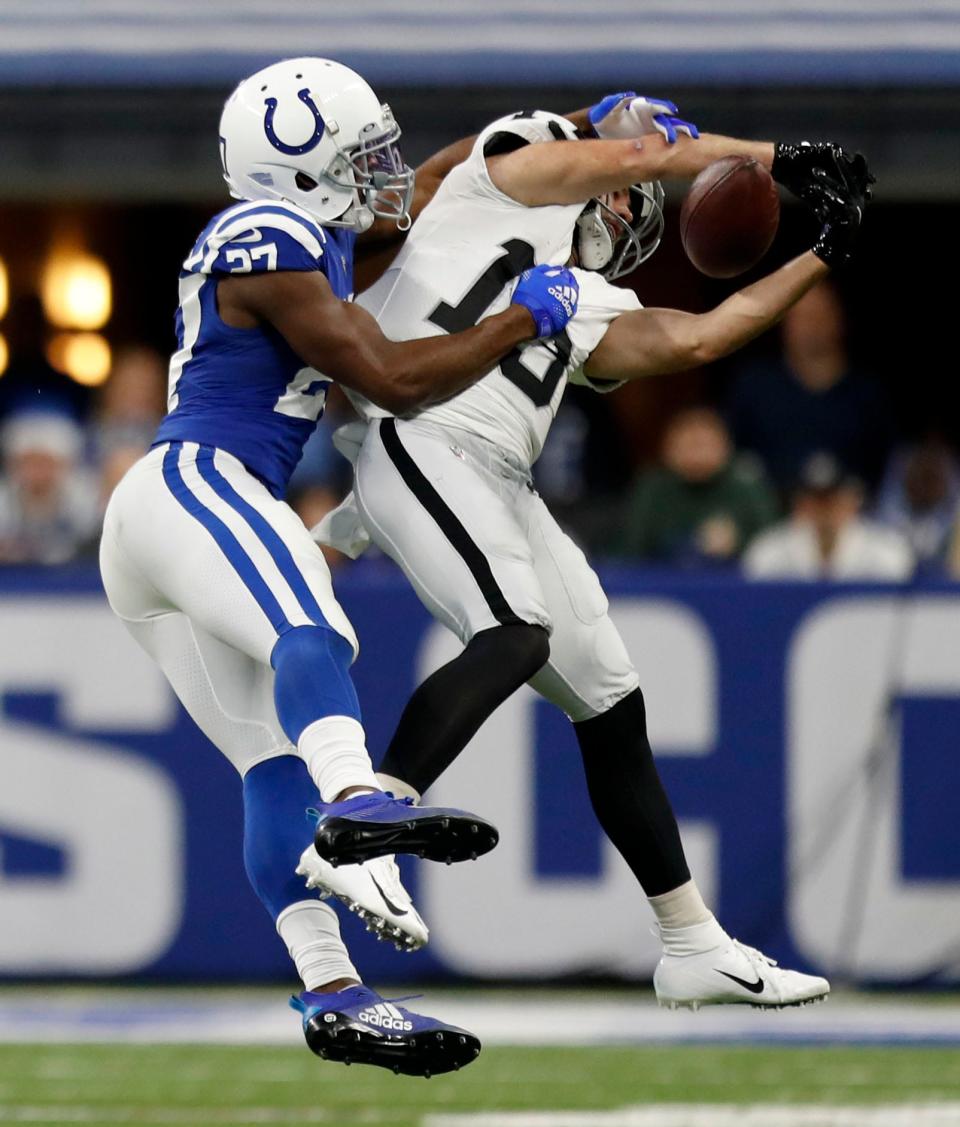 Indianapolis Colts cornerback Xavier Rhodes (27) breaks up a pass intended for Las Vegas Raiders wide receiver Hunter Renfrow (13) on Sunday, Jan. 2, 2022, during a game at Lucas Oil Stadium in Indianapolis.