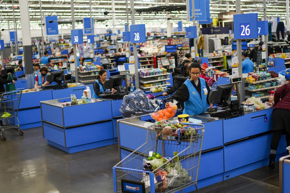 FILE - Cashiers process purchases at a Walmart Supercenter in North Bergen, N.J., on Feb. 9, 2023. Retailers, including Walmart and Target, are stepping up discounting heading into the summer of 2024, as they hope to offer frustrated shoppers some relief from higher prices and entice them to open their wallets.(AP Photo/Eduardo Munoz Alvarez, File)