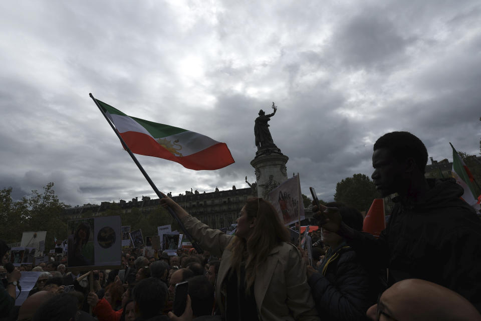 Protesters gather before a demonstration to support Iranian women, Sunday, Oct. 2, 2022 in Paris. Thousands of Iranians have taken to the streets over the last two weeks to protest the death of Mahsa Amini, a 22-year-old woman who had been detained by Iran's morality police in the capital of Tehran for allegedly not adhering to Iran's strict Islamic dress code. (AP Photo/Aurelien Morissard)