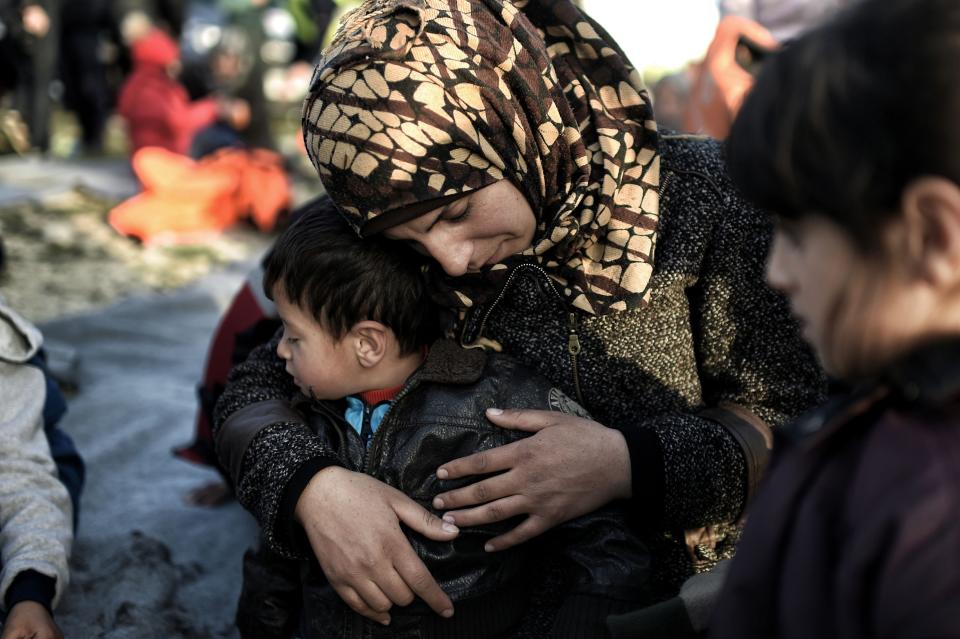 A woman hugs a boy after arriving to Lesbos on Feb. 29, 2016.