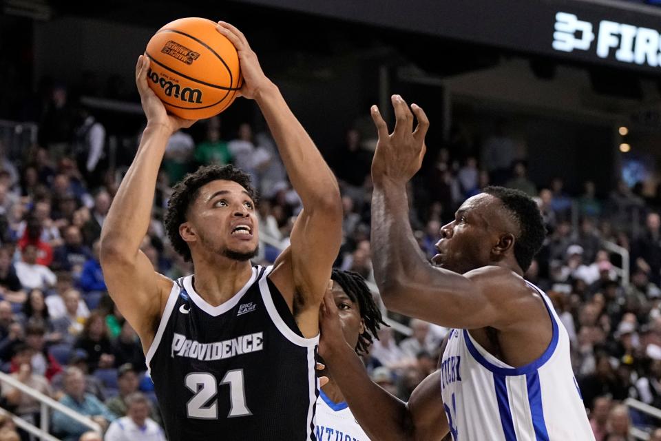 Providence forward Clifton Moore shoots over Kentucky forward Oscar Tshiebwe during the first half of a first-round college basketball game in the NCAA Tournament on Friday, March 17, 2023, in Greensboro, N.C. (AP Photo/Chris Carlson)