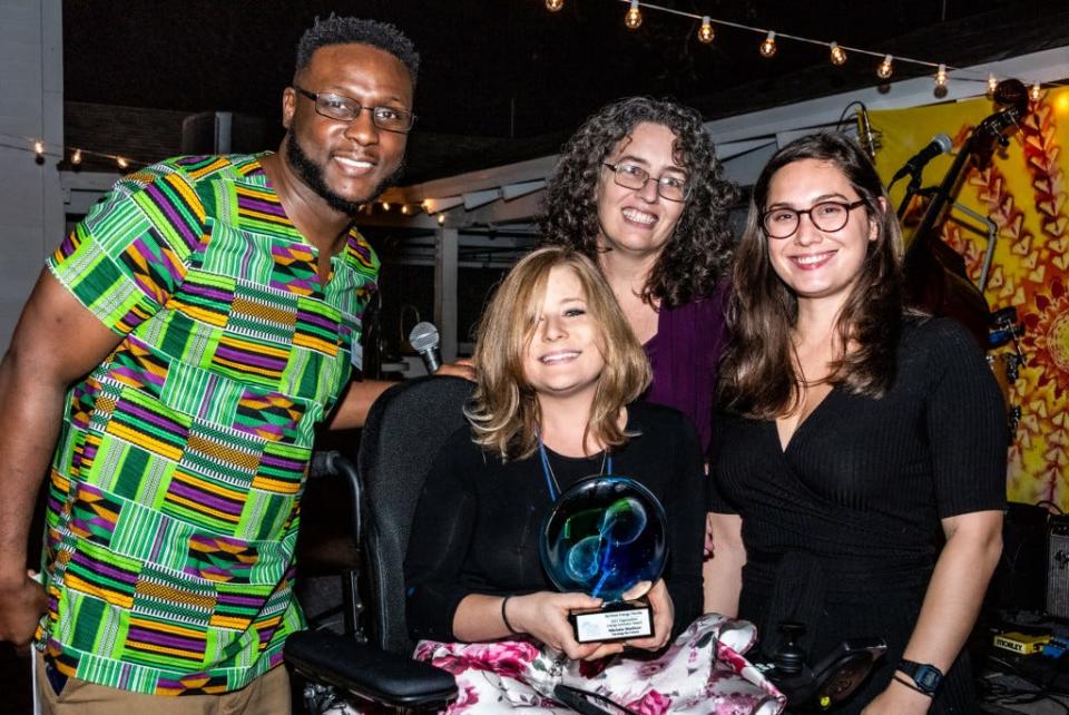 Michele Madison (center), CEO and founder of Farming of the Future, receives ReThink Energy's Innovator Award at the 2021 Energy Ball last fall. Also pictured are Bruce Strouble (from left), Kim Ross and City Commissioner Jack Porter.