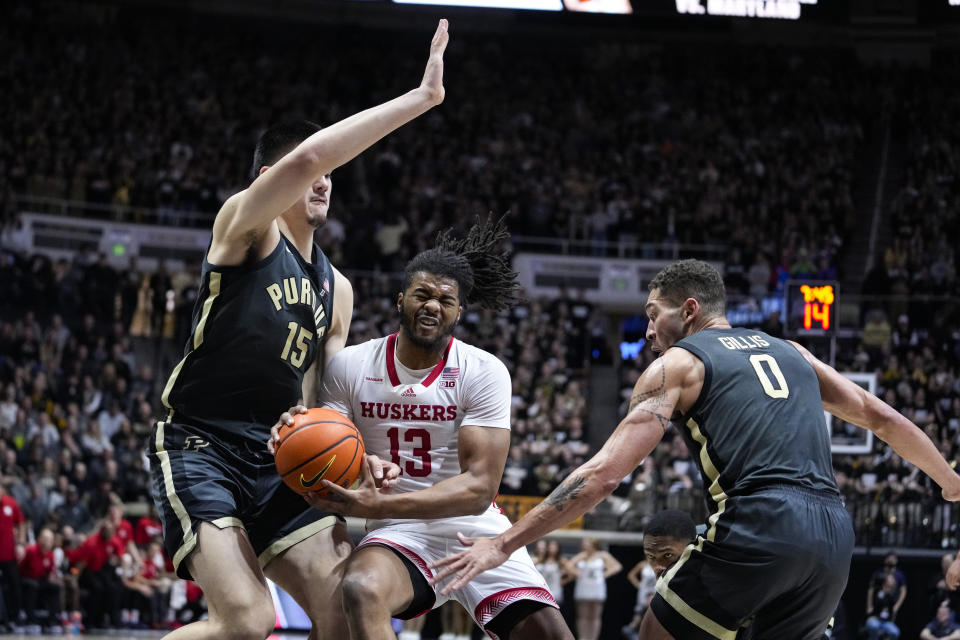 CORRECTS PLAYER AT LEFT TO ZACH EDEY, INSTEAD OF DAVID JENKINS JR. - Nebraska forward Derrick Walker (13) cuts between Purdue center Zach Edey, left, and forward Mason Gillis (0) during the first half of an NCAA college basketball game in West Lafayette, Ind., Friday, Jan. 13, 2023. (AP Photo/Michael Conroy)