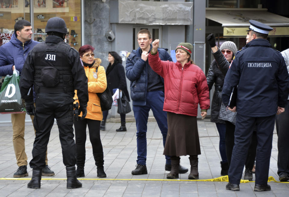 Bosnian Serb police secure an area at the spot where Davor Dragicevic along with members of the "Justice for David" movement protested and demanded the truth behind the death of 21-year-old David Dragicevic in the Bosnian town of Banja Luka, northwest of Sarajevo, Bosnia, Tuesday, Dec. 25, 2018. Bosnian Serb police have detained Davor Dragicevic, the man whose quest for the truth over the death of his son has sparked months of anti-government protests. (AP Photo/Radivoje Pavicic)