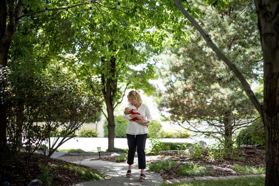 Cindy Davis walks through her backyard with her 9-week-old granddaughter Indy while babysitting her at home in Cedar Hills on Tuesday, Aug. 15, 2023. | Spenser Heaps, Deseret News