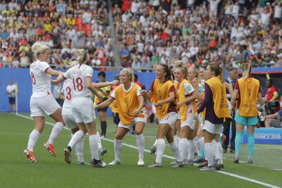 England's Alex Greenwood celebrates with her teammates after scoring her side's 3rd goal during the Women's World Cup round of 16 soccer match between England and Cameroon at the Stade du Hainaut stadium in Valenciennes, France, Sunday, June 23, 2019. (AP Photo/Michel Spingler)