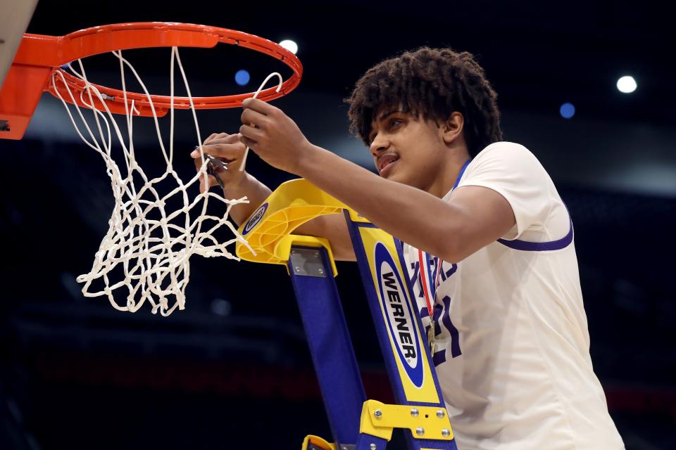 Central junior Devin Royal cuts down the net after the state title victory. A first-team all-district honoree and OCC-Buckeye Player of the Year, Royal scored 16 of his 20 points in the second half of the championship game.