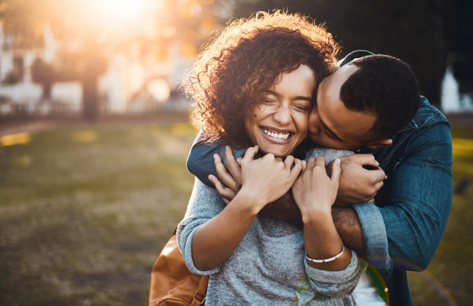 guy hugging a woman from behind