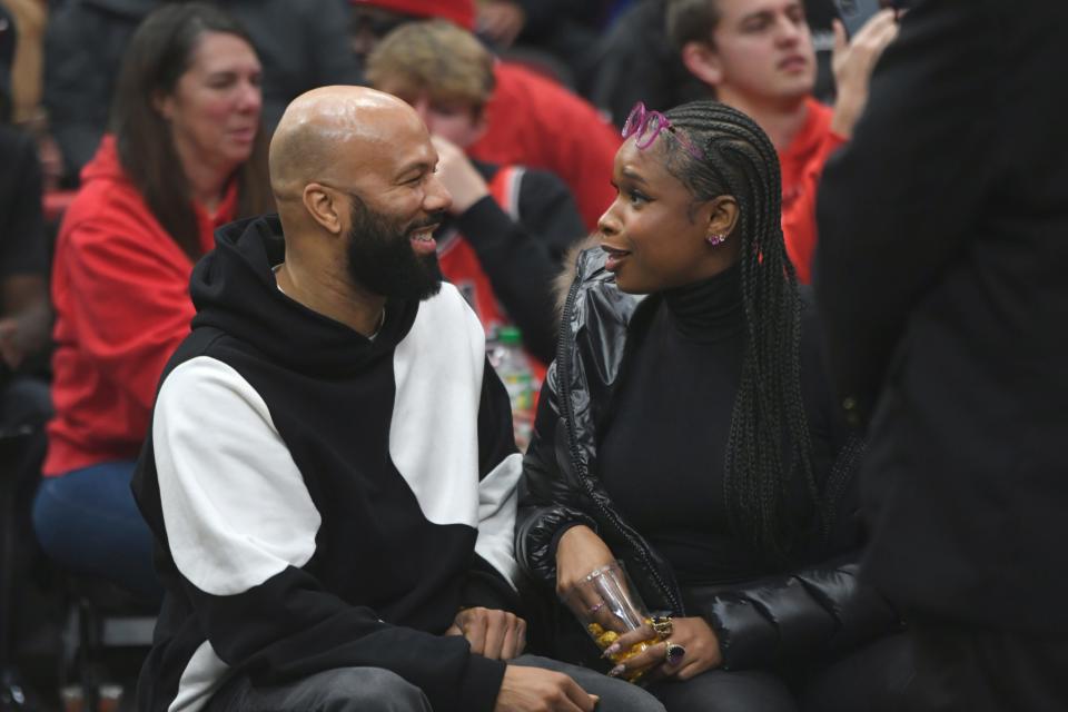 December 30, 2023 : Rapper and actor Common, left, and singer and actress Jennifer Hudson, right, talk during an NBA basketball game between the Chicago Bulls and the Philadelphia 76ers in Chicago.