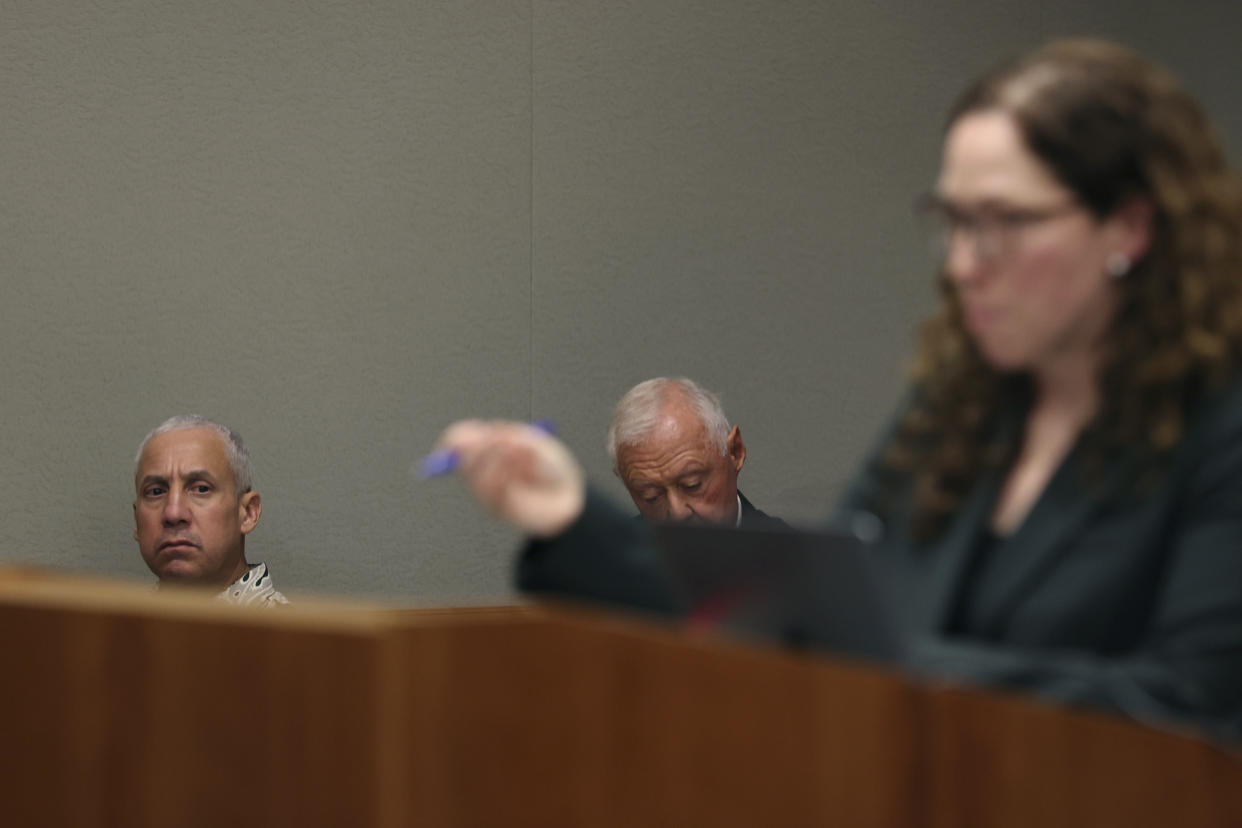 Albert "Ian" Schweitzer, left, looks on as Innocence Project attorney Susan Freidman speaks during Schweitzer's court case Tuesday, Jan. 24, 2023, in Hilo, Hawaii. Attorneys for Schweitzer, imprisoned for more than 20 years after his conviction for the 1991 sexual assault, kidnapping, and murder of a white woman visiting the Big Island, ask a judge Tuesday to dismiss his conviction due to new evidence, including DNA testing in the case. (Marco Garcia/The Innocence Project via AP Images)