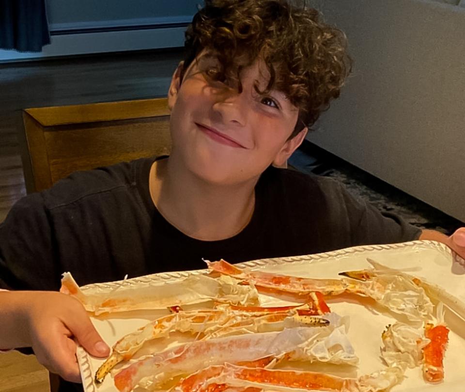 Peter Romano smiles over a plate of crab legs during a recent family vacation.