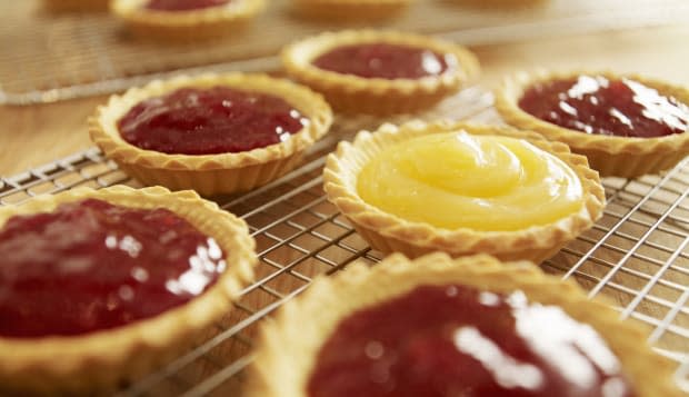 Close up of jam tarts cooling on wire racks