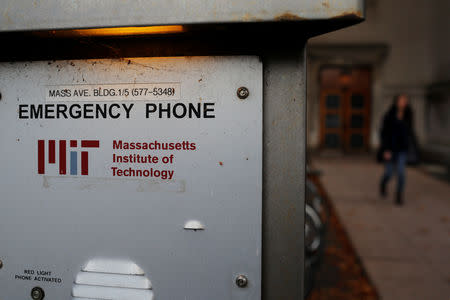A woman walks past an emergency phone outside a building at the Massachusetts Institute of Technology (MIT) in Cambridge, Massachusetts, U.S., November 21, 2018. REUTERS/Brian Snyder