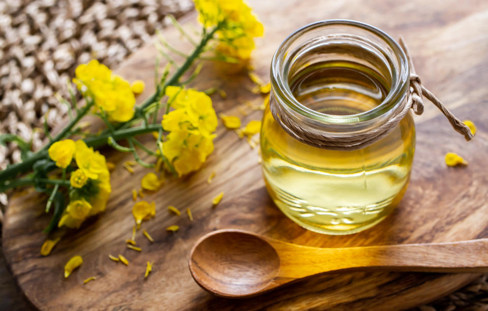 Jar of rapeseed oil (canola), and rape blossoms. (Getty Images)