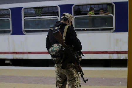 A soldier guards a train at a station near recently opened international fair in Damascus, Syria, September 12, 2018. REUTERS/Marko Djurica