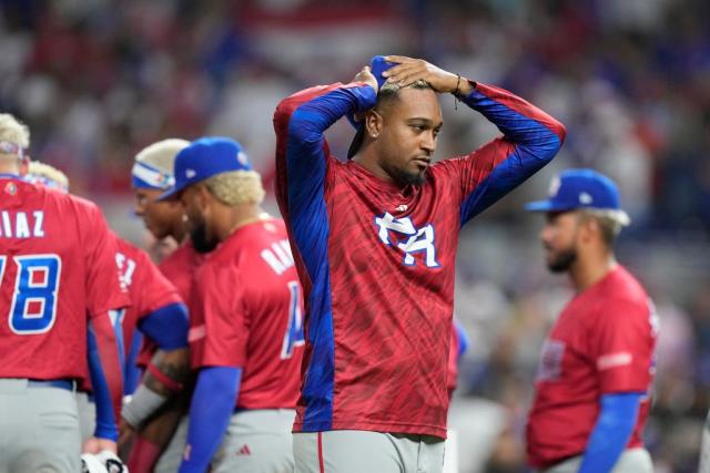 Puerto Rico players react after pitcher Edwin Diaz appeared to be injured during postgame celebration after Puerto Rico beat the Dominican Republic 5-2 during a World Baseball Classic game, Wednesday, March 15, 2023, in Miami. (AP Photo/Wilfredo Lee)