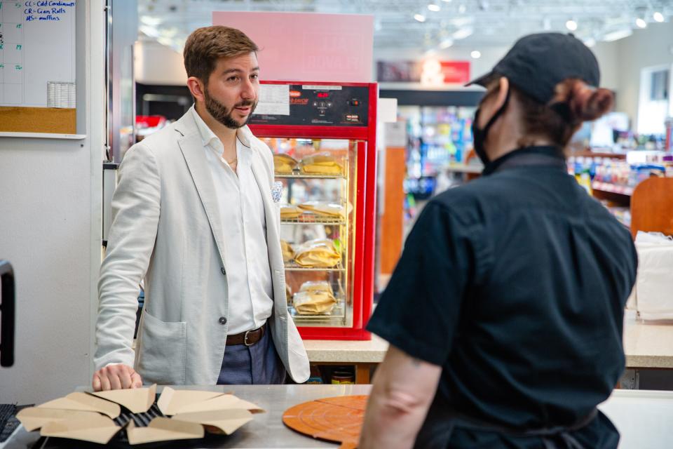Kum & Go CEO Tanner Krause talks with employee Kim Rubis during a store visit.