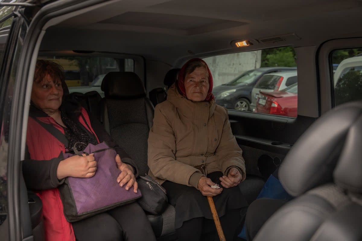 Tetiana (C), 82, an evacuee from a village in Vovchansk district, waits in a minivan at an evacuation point in Kharkiv, on May 11 (AFP via Getty Images)
