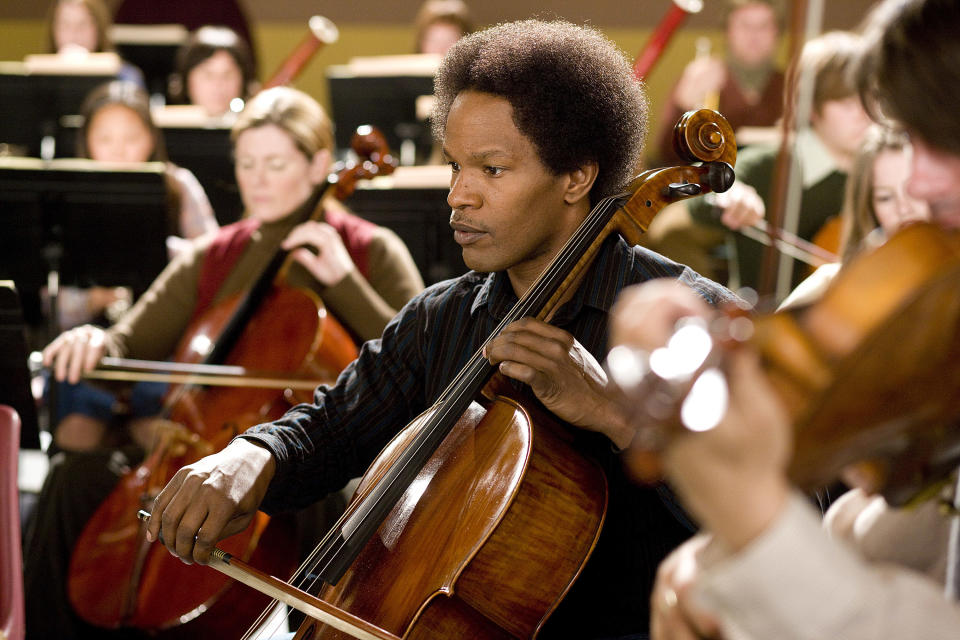 Ayers playing cello in a professional orchestra