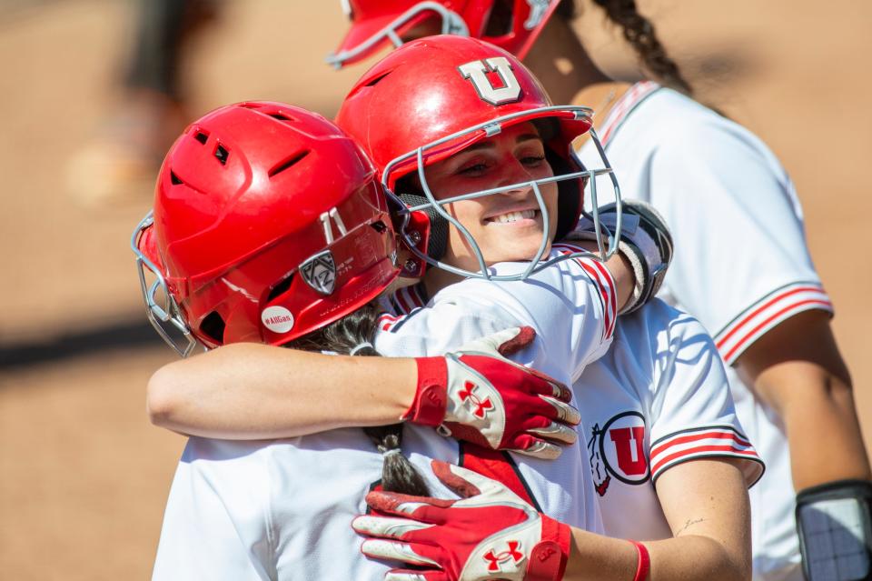 AJ Militello (center) celebrates one of her five home runs during the 2021 softball season with Utah teammate Jordyn Gasper (left).