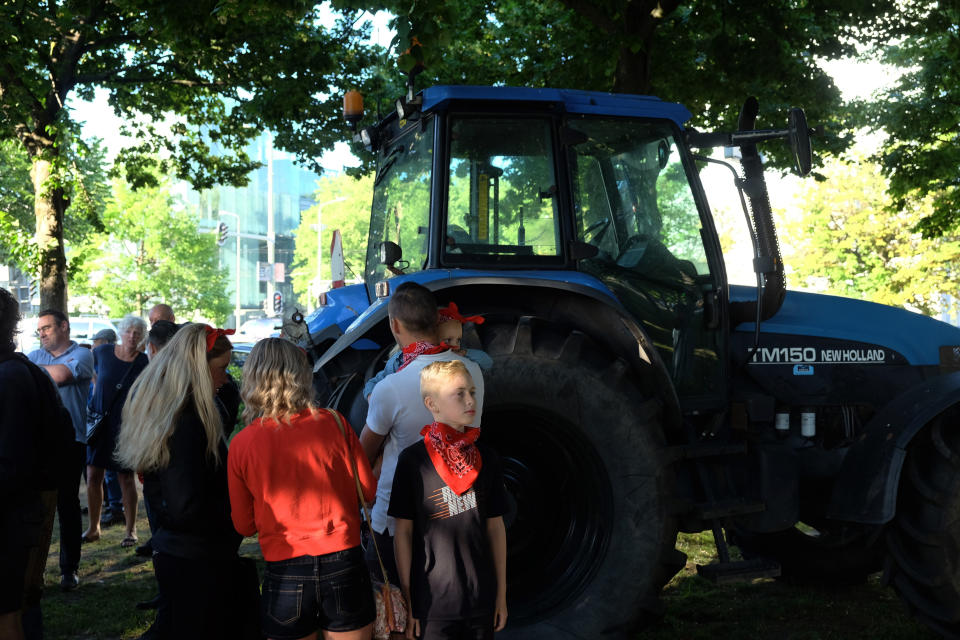 A small group of people gather ahead of a major protest by farmers at a village in central Netherlands, in The Hague, Netherlands, Wednesday, June 22, 2022. Thousands of farmers are driving their tractors along roads and highways across the Netherlands, heading for a mass protest against the Dutch government’s plans to rein in emissions of nitrogen oxide and ammonia. (AP Photo/Michael Corder)