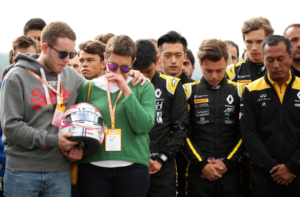 The mother and brother of Anthoine Hubert hold his during a moment of silence at the Belgian Formula One Grand Prix circuit in Spa-Francorchamps, Belgium, on Sept. 1, 2019. The 22-year-old Hubert died following an estimated 160 mph (257 kph) collision on Lap 2 at the high-speed Spa-Francorchamps track, which earlier Saturday saw qualifying for Sunday's Formula One race.