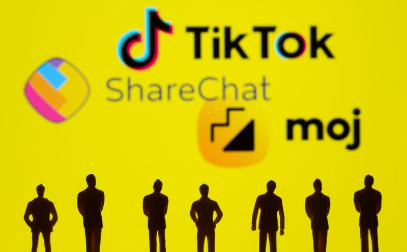 Small toy figures are seen in front of displayed TikTok, ShareChat and Moj logo in this illustration taken