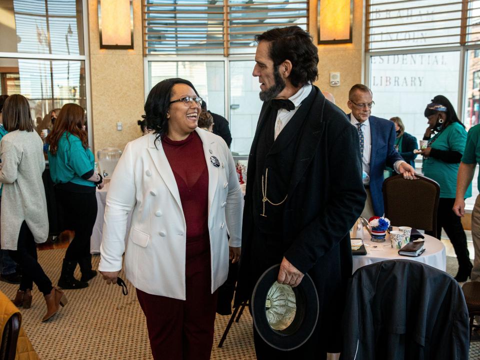 Christina Shutt, executive director of the Abraham Lincoln Presidential Library and Museum, visits with Abraham Lincoln, portrayed by Randy Duncan, during an event to kick off the Abraham Lincoln Presidential Library and Museum’s membership program in Springfield, Ill., Wednesday, December 1, 2021. [Justin L. Fowler/The State Journal-Register]