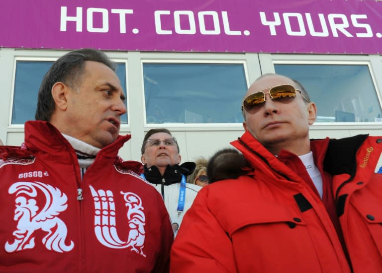 Russia's President Vladimir Putin (R) and Sports Minister Vitaly Mutko attend the men's cross-country 4 x 10 km relay event at the 2014 Sochi Winter Olympics on February 16, 2014