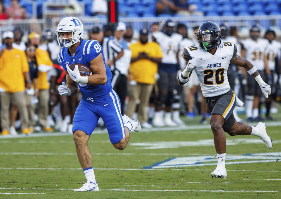Duke's Nicky Dalmolin (81) carries the ball for a touchdown after completing a pass ahead of North Carolina A&T's Avarion Cole (20) during the first half of an NCAA college football game in Durham, N.C., Saturday, Sept. 17, 2022. (AP Photo/Ben McKeown)