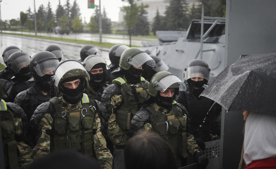 Riot police line block the road to stop Belarusian opposition supporters rally near the Palace of Independence in Minsk, Belarus, Sunday, Sept. 6, 2020. Sunday's demonstration marked the beginning of the fifth week of daily protests calling for Belarusian President Alexander Lukashenko's resignation in the wake of allegedly manipulated elections. (AP Photo/TUT.by)