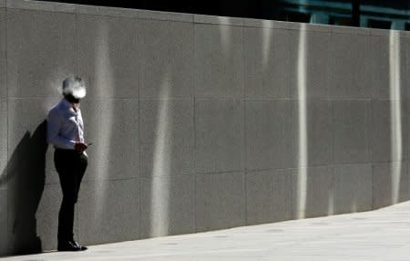 FILE PHOTO: A man uses an electronic cigarette on a sunny spring day in London, April; 14, 2015. REUTERS/Cathal MacNaughton