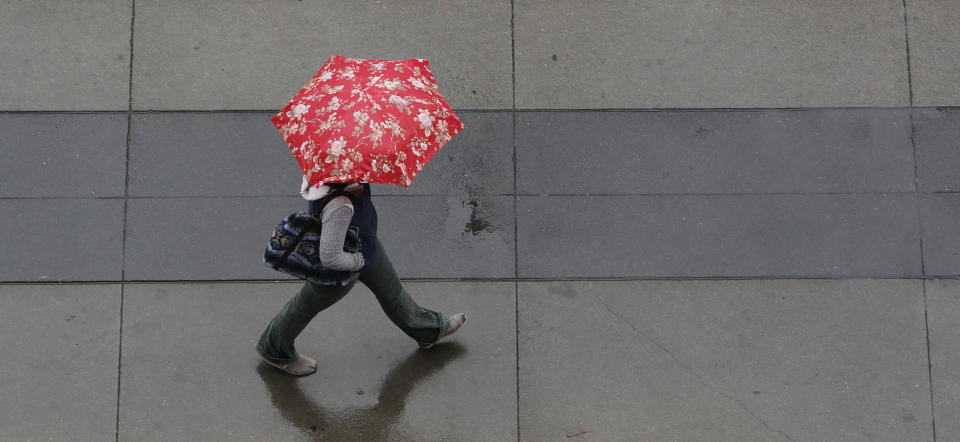 Umbrellas were put to good use as showers swept through Sacramento, Calif., Friday, Feb. 7, 2014. Drought-stricken California is getting some relief as a storm system the likes of which, forecasters say, the region has not seen in more than a year.(AP Photo/Rich Pedroncelli)