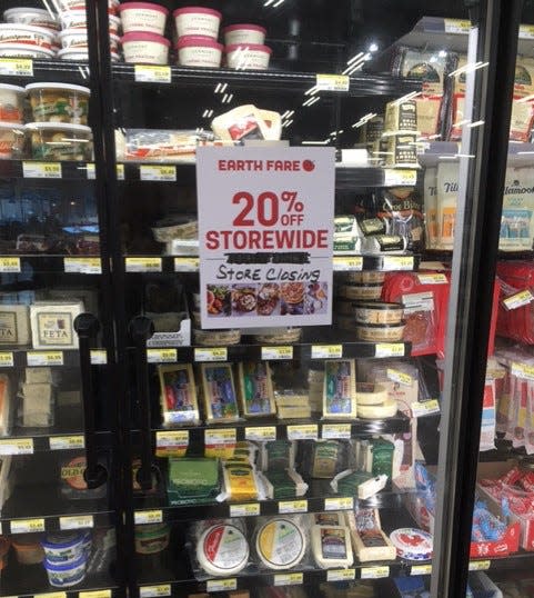 Signs at Earth Fare advertise 20 percent discounts on foods and other goods at the store as part of its liquidation sale.