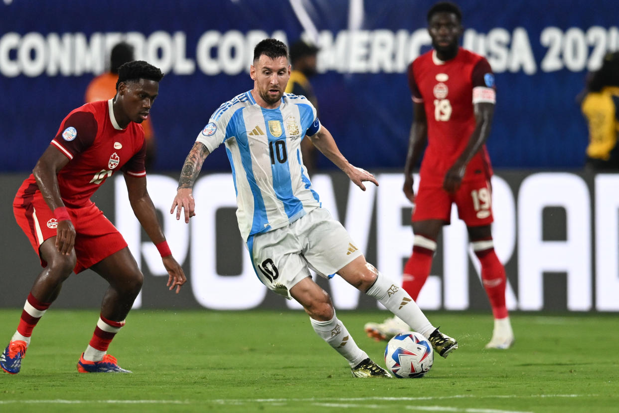 EAST RUTHERFORD, NEW JERSEY - JULY 9: Lionel Messi #10 of Argentina dribbles the ball past Jonathan David #10 of Canada during the Copa America 2024 semifinal match between Argentina and Canada at MetLife Stadium on July 9, 2024 in East Rutherford, New Jersey. (Photo by Stephen Nadler/ISI Photos/Getty Images)