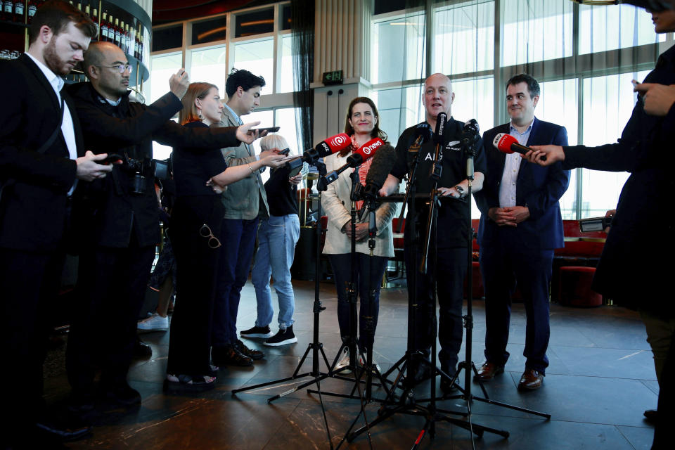 New Zealand National Party leader and Prime MInister elect Christopher Luxon, second right, comments to media in Auckland, Sunday, Oct. 15, 2023, following his victory in a national election on Saturday. (Alex Burton/New Zealand Herald via AP)