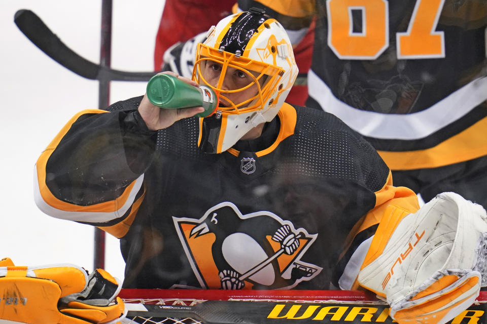 Pittsburgh Penguins goaltender Casey DeSmith drinks during the third period of an NHL hockey game against the Columbus Blue Jackets in Pittsburgh, Friday, April 29, 2022. (AP Photo/Gene J. Puskar)