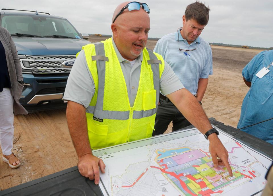 Adam Lee, senior project manager, and Trip Tollison, president and CEO of the Savannah Economic Development Authority, comb over the site map at the Bryan County megasite.