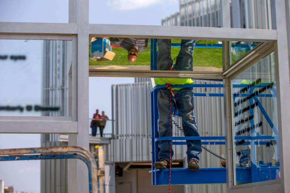 A worker helps finish installing "Multiple Voices," by artist Eva Schlegel, on Aug. 30 at Campbell Art Park outside Oklahoma Contemporary Arts Center in Oklahoma City.
