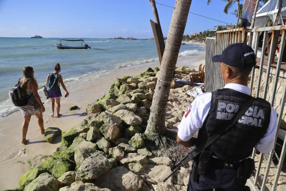 Police guard the exit of the Blue Parrot nightclub in Playa del Carmen, Mexico, Monday, Jan. 16, 2017. A deadly shooting occurred in the early morning hours outside the nightclub while it was hosting part of the BPM electronic music festival, according to police. (AP Photo)