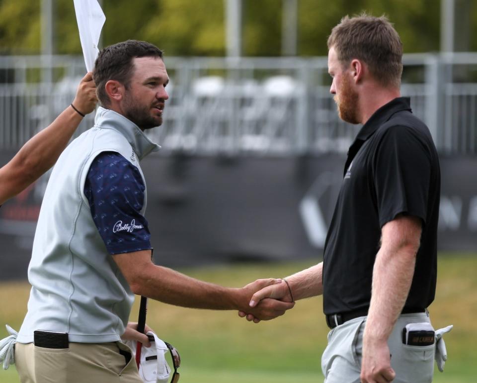 Brandon Crick, left, shakes hands with Pontus Nyholm after completing the final hole of the first round of the Memorial Health Championship at Panther Creek Country Club on Thursday, June 29, 2023.