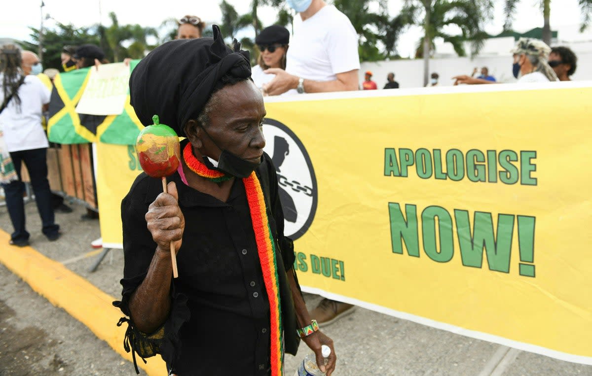 People calling for slavery reparations, protest outside the entrance of the British High Commission during the visit of the Duke and Duchess of Cambridge in Kingston, Jamaica (AFP via Getty Images)