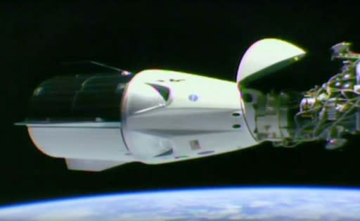 A video grab taken from a NASA/SpaceX webcast transmission on March 3, 2019 shows SpaceX Dragon capsule docked at the International Space Station
