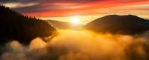 <p>Sunrise over mist-covered mountains in Austria. </p>